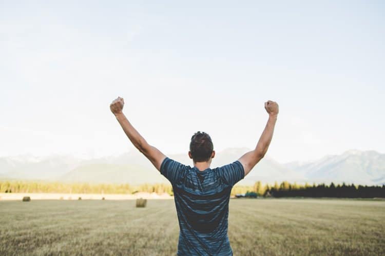 man with raised hand